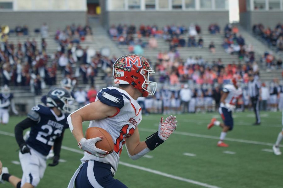 Junior Brock Murtaugh runs for a 1st down in the game against Lincoln North Star. Photo by Ally Seevers