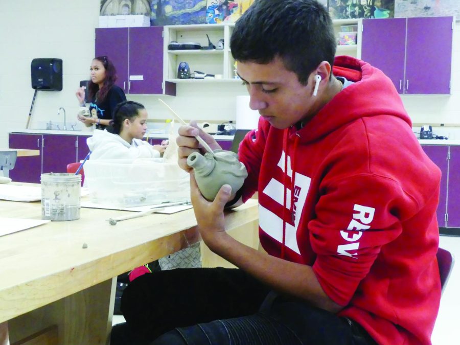 Junior DJ Gutirrez carefully shapes his ugly jug in Melanie
Mitera’s Art Foundations class. He is shaping his ugly jug to
make it look scary, based off of its original purpose of scaring off evil spirits. 