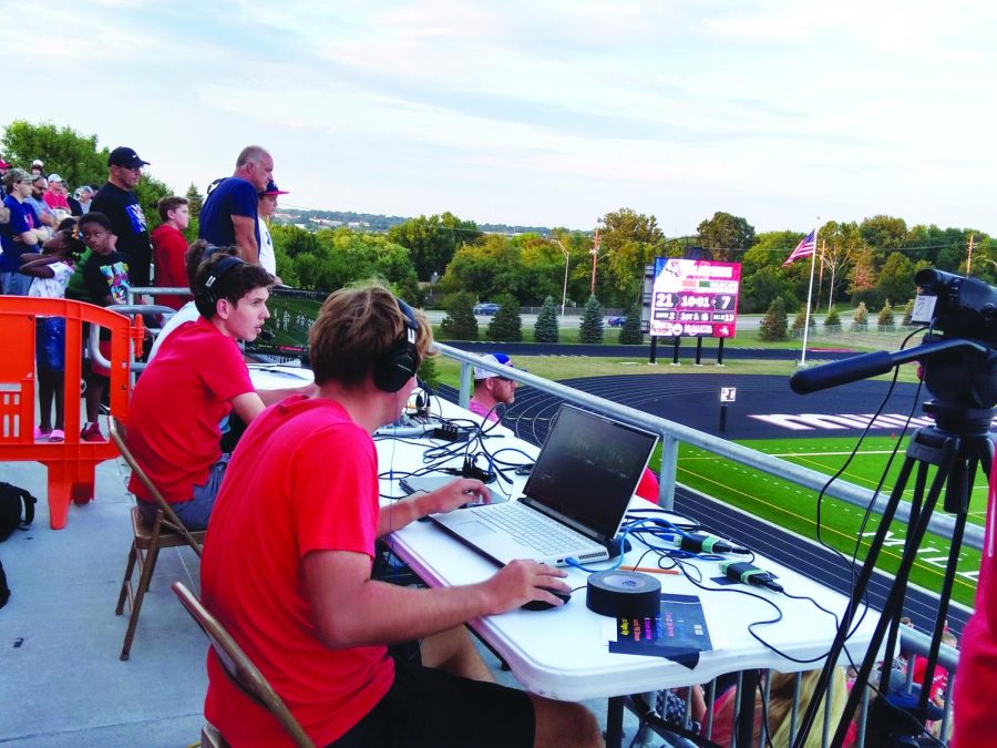Set up outside on the concourse right alongside fans, senior Taylor Lewis produces the first home football livestream of the season while juniors Jonathan Spieler and Wilson Dittman commentate.