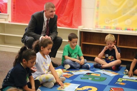 Superintendent Dr. John Schwartz gathers with Montclair Elementary students on the rug to be part of a reading
activity.
