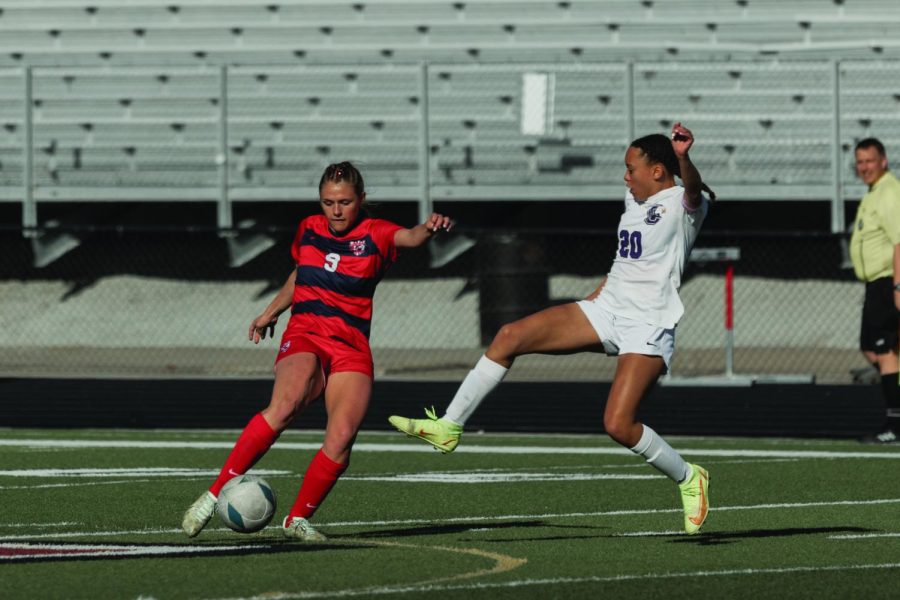 Sophomore Alyse Aschebrook works to keep the ball from the opposing striker in
the district game against Central.