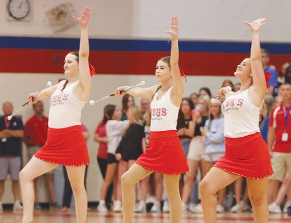 Junior Aspen Christine and Freshmen Addelyn Stapp and Macy Whiting strike a pose to finish their routine at the fall pep rally.