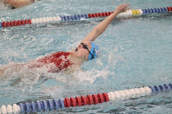 Senior Emily Walters competes in the 100 m backstroke in meet against Lewis Central.