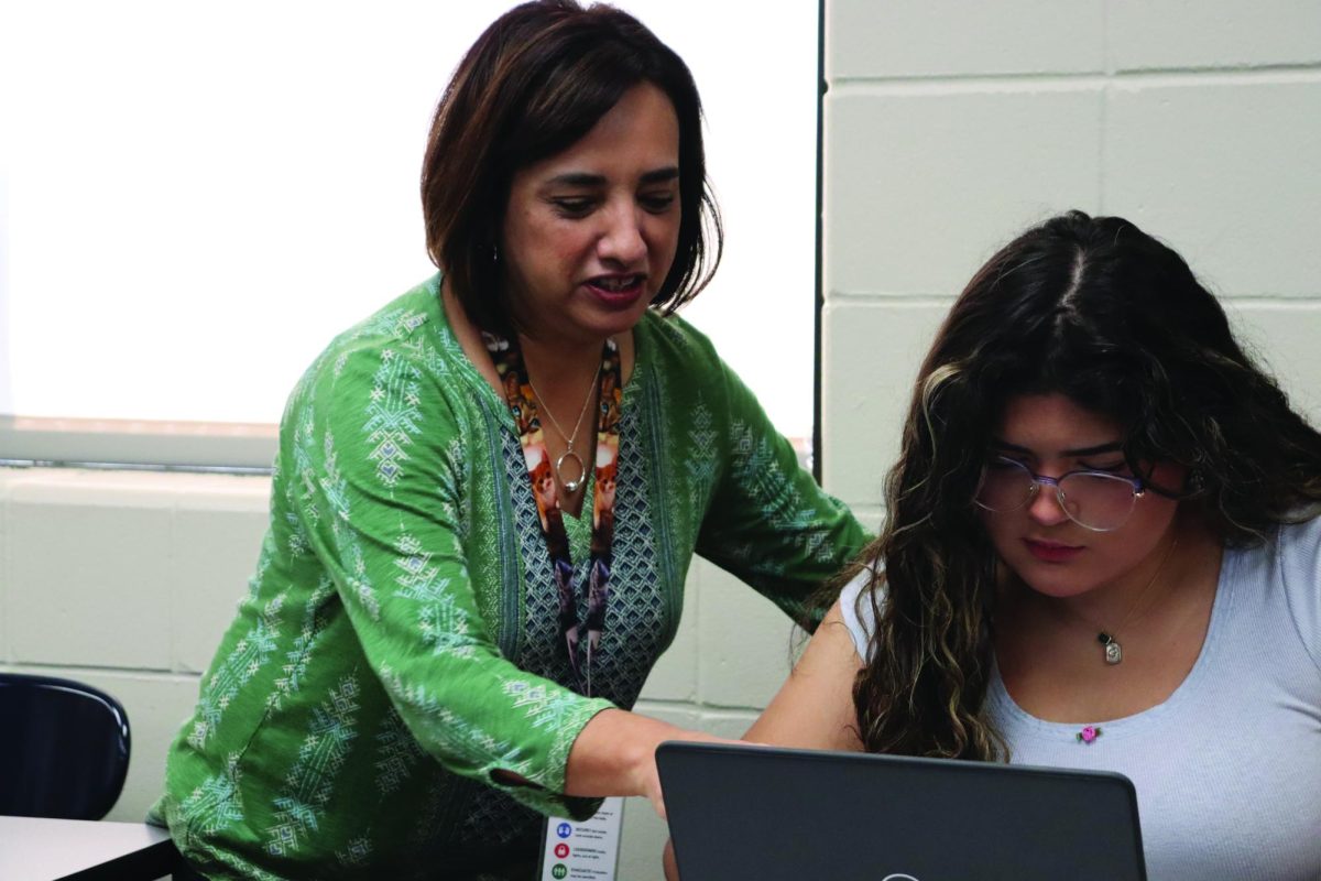 Spanish teacher Juventina Sloter helps sophomore Paullet Flores study for her final exam.