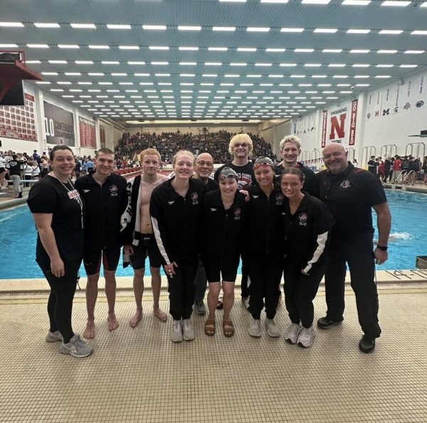 Millard South state team swimmers and coaches pose before the finals round of the 2024 NSAA State Swimming Championships.

Front row, from left to right: Kindsey Joyce (11), Emily Walters (12), Addisyn Storms (11), Parker Schmeiding (11)

Back row, from left to right: Coach Tara Goss, Oscar Edwards (10), Chase Zagurski (12), Coach Rob Wennstedt, Nik Keuser (12), Mason Zadina (11), Coach Tyler Hammond