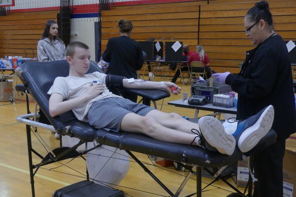 Senior Matthew Kelding prepares to donate blood.