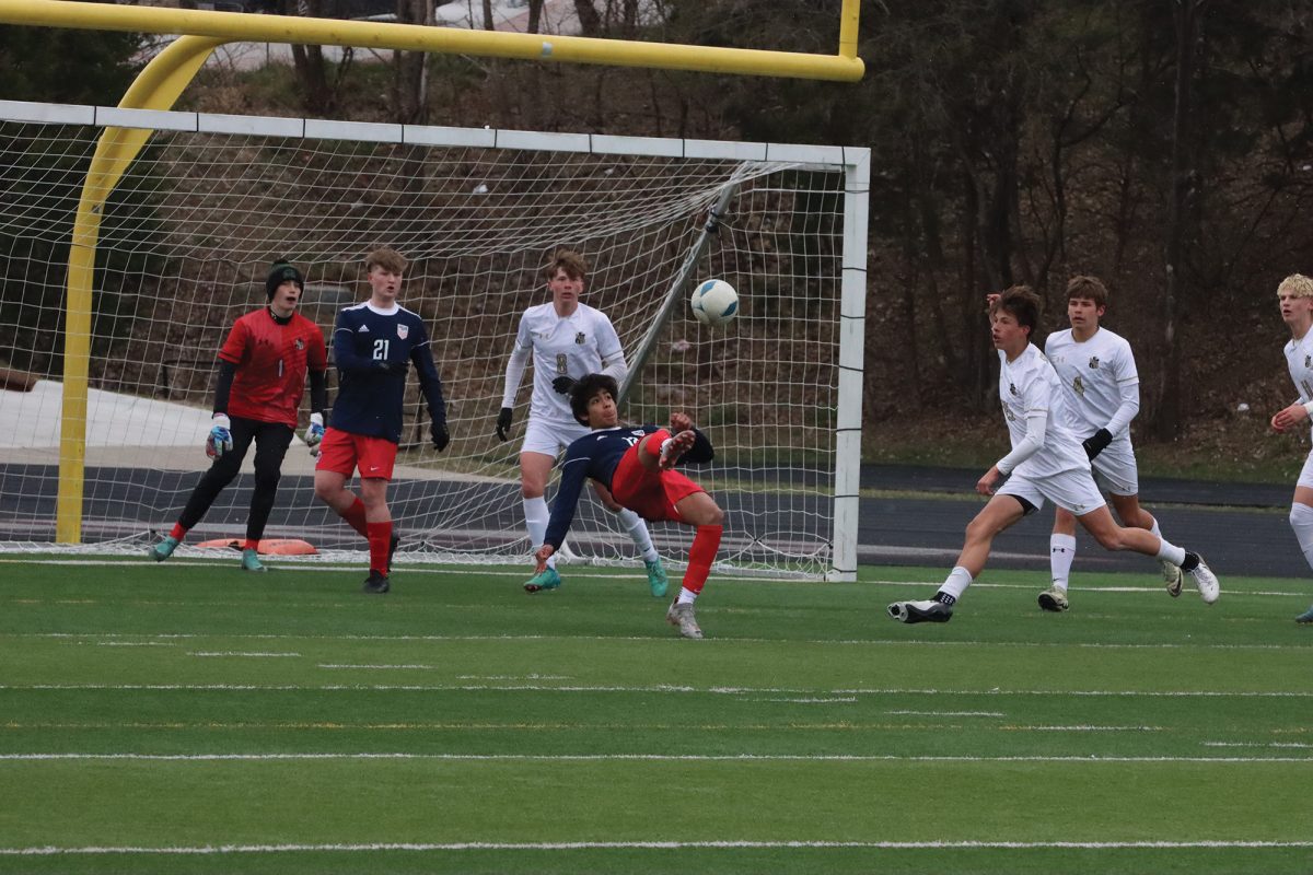 Junior Karlo Rodriguez launches ball towards goal in match against Omaha Burke.