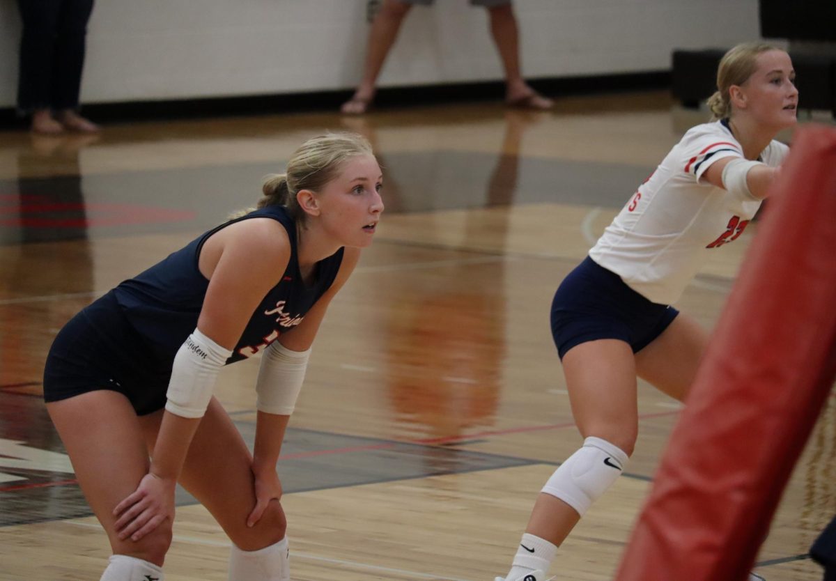 Jamie Murceck and Nevaeh Jacobson prepare as the ball shoots from the opposite team.