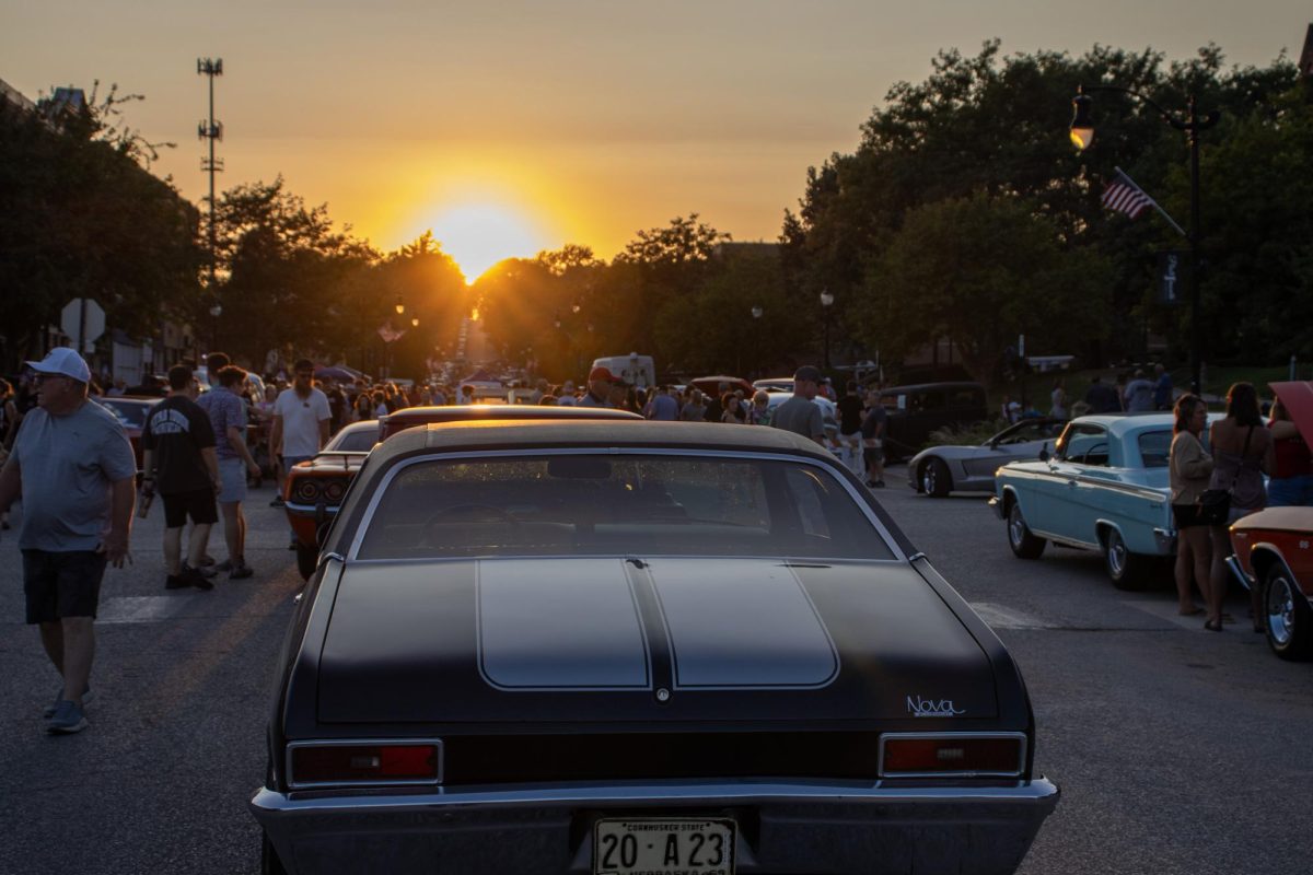 Chevy Nova parked in the middle of the road for the car show. 