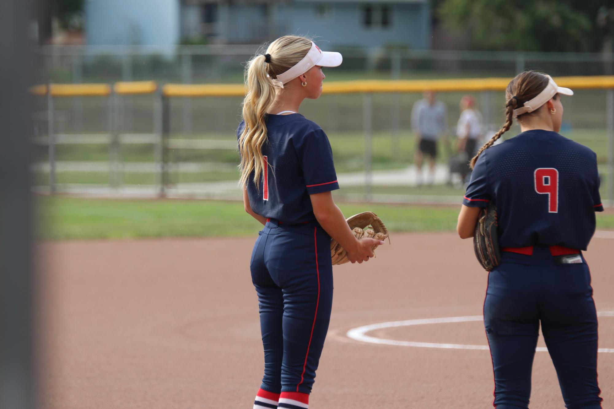 Emorie Swanson stands on the line while the announcer calls out her teammates names 