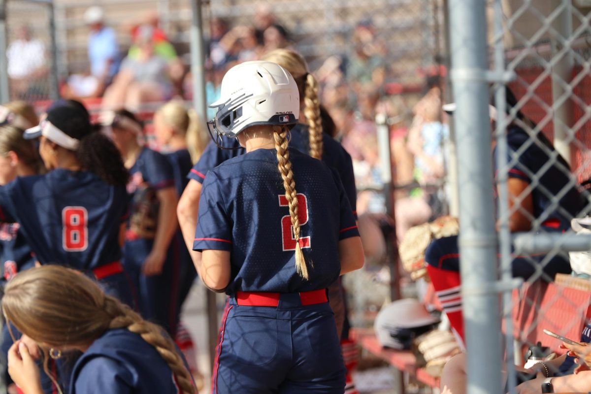 Teagan Noelle watching her teammates   after her at bat