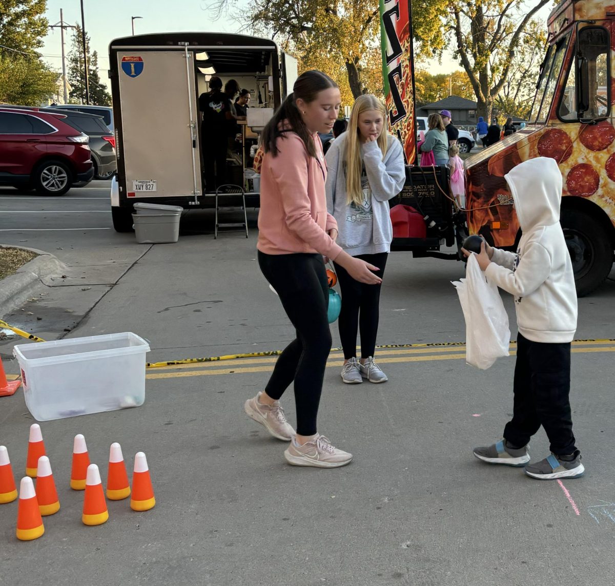 LEO club members Claire Kirkebak and Ella Langseth vrun the candy corn bowling booth at the Norris Elementary fall carnival.