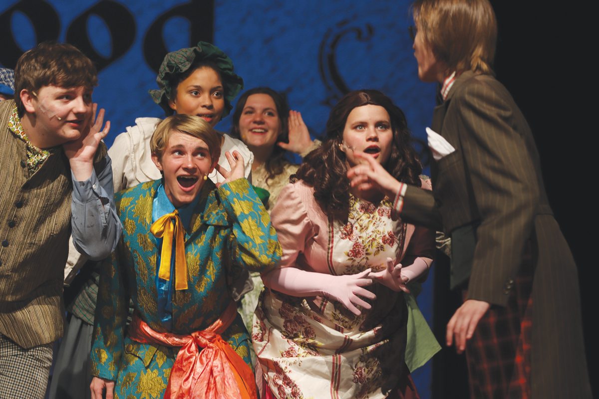 The suspects and ensamble (Zach Nelson, Rugor Aden, Ari Barnhardt, Kelsi Tegankamp, and Chloe Fowler) listen anxiously. 