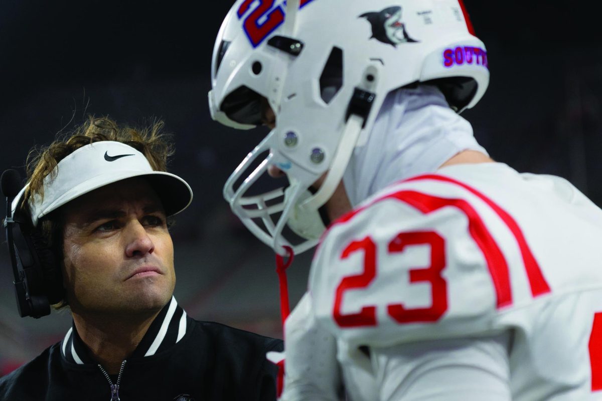 Coach Ty Wisdom and senior Chase Loftin discuss the plays
during the second quater, as the Patriots were down 6 to 10.