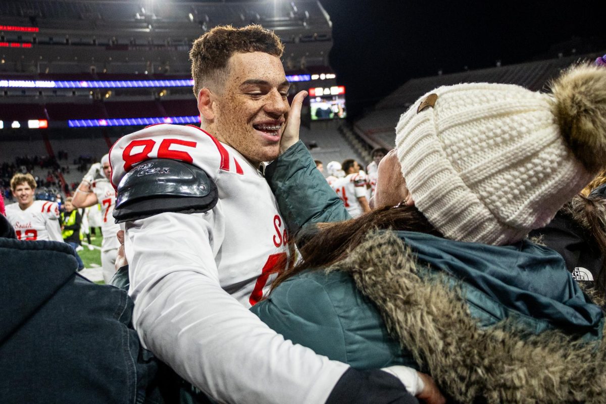 A loving embrace from senior Soloman Baker and his mother after the Millard South Patriots won the NSAA Football Championship against Omaha Westside 27-10. 