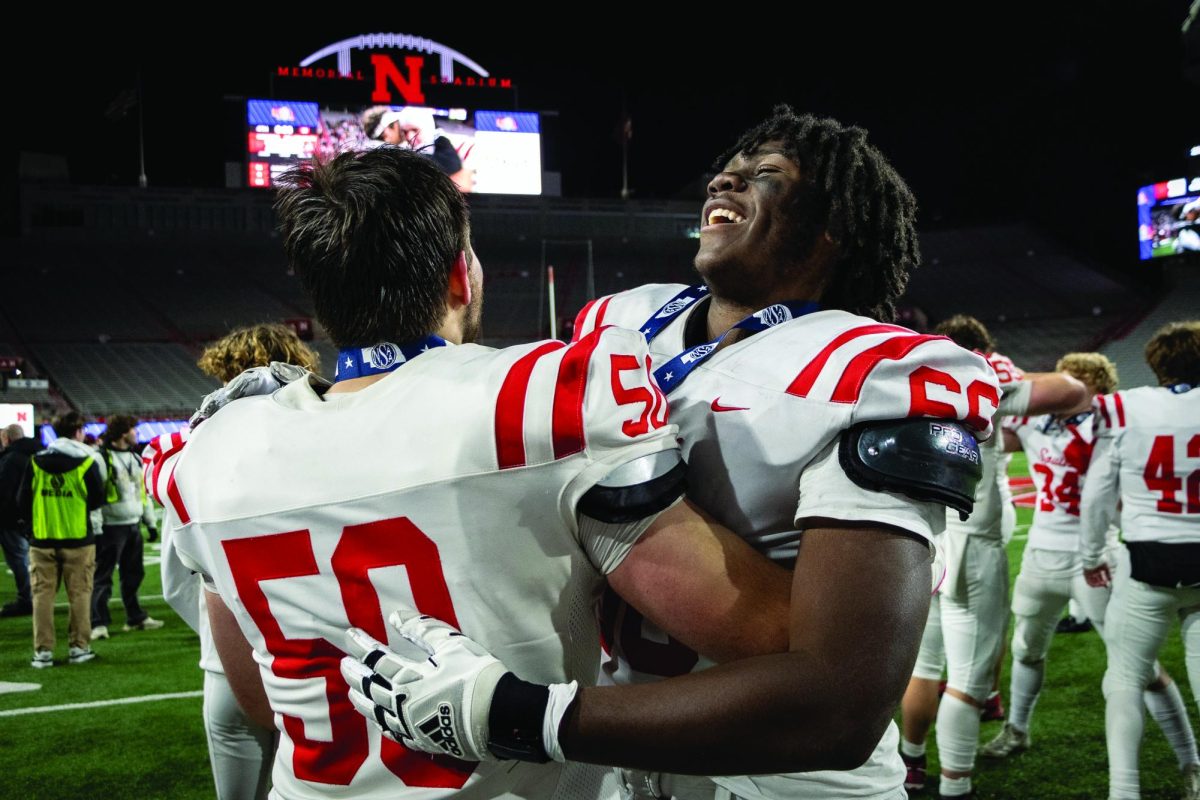 Junior Antonio Harris and junior Jack Ladd celebrate their first state title after the medals ceremony.