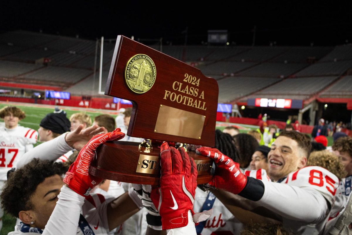 The team holds their newly earned NSAA State Football Championship title high. 