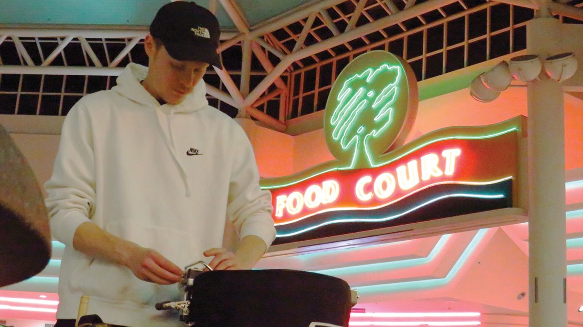 John Benson, a member of Spark, retunes a snare drum during a rehearsal at the Oakview Mall.