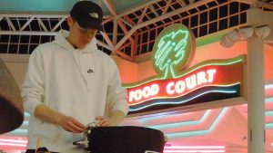 John Benson, a member of Spark, retunes a snare drum during a rehearsal at the Oakview Mall.