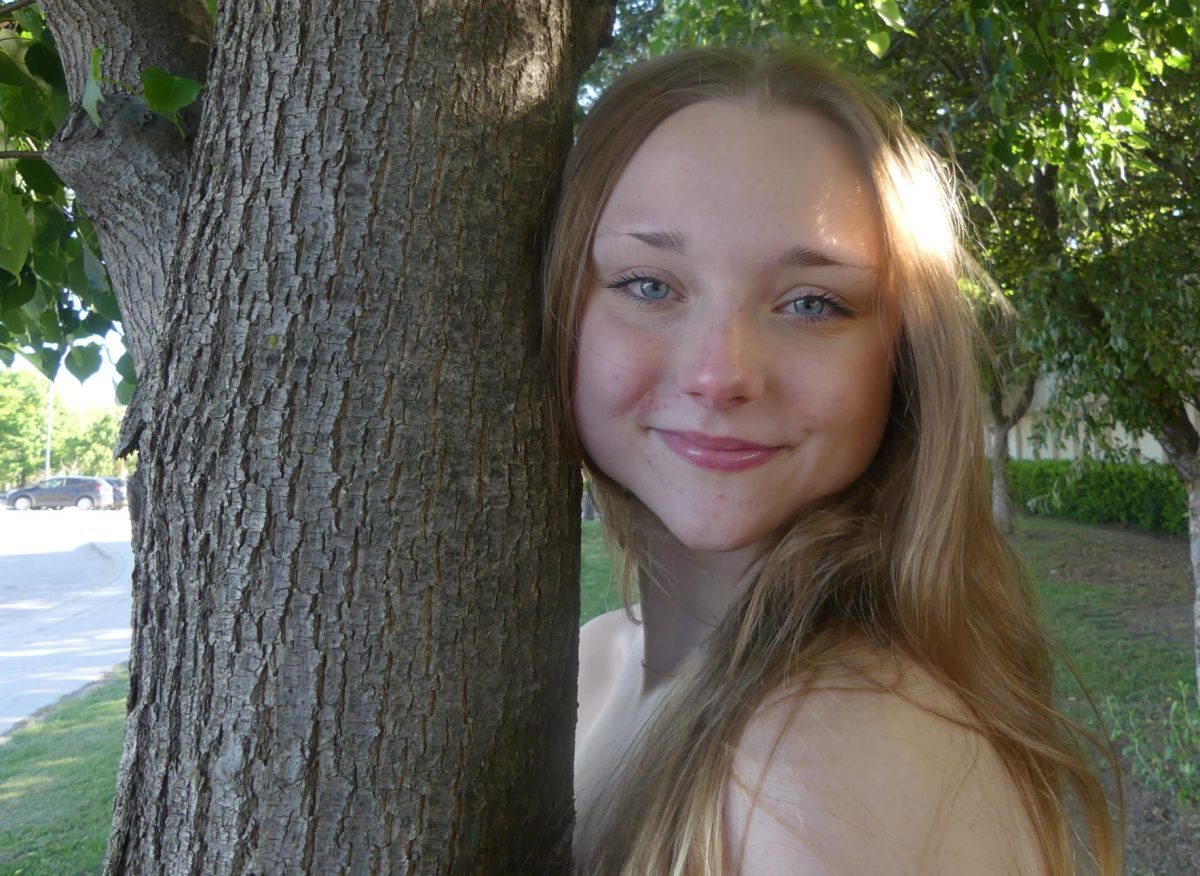Sophomore Victoria Richards poses to show flattering light in the Intro to Journalism Outdoor portrait photo shoot during class.