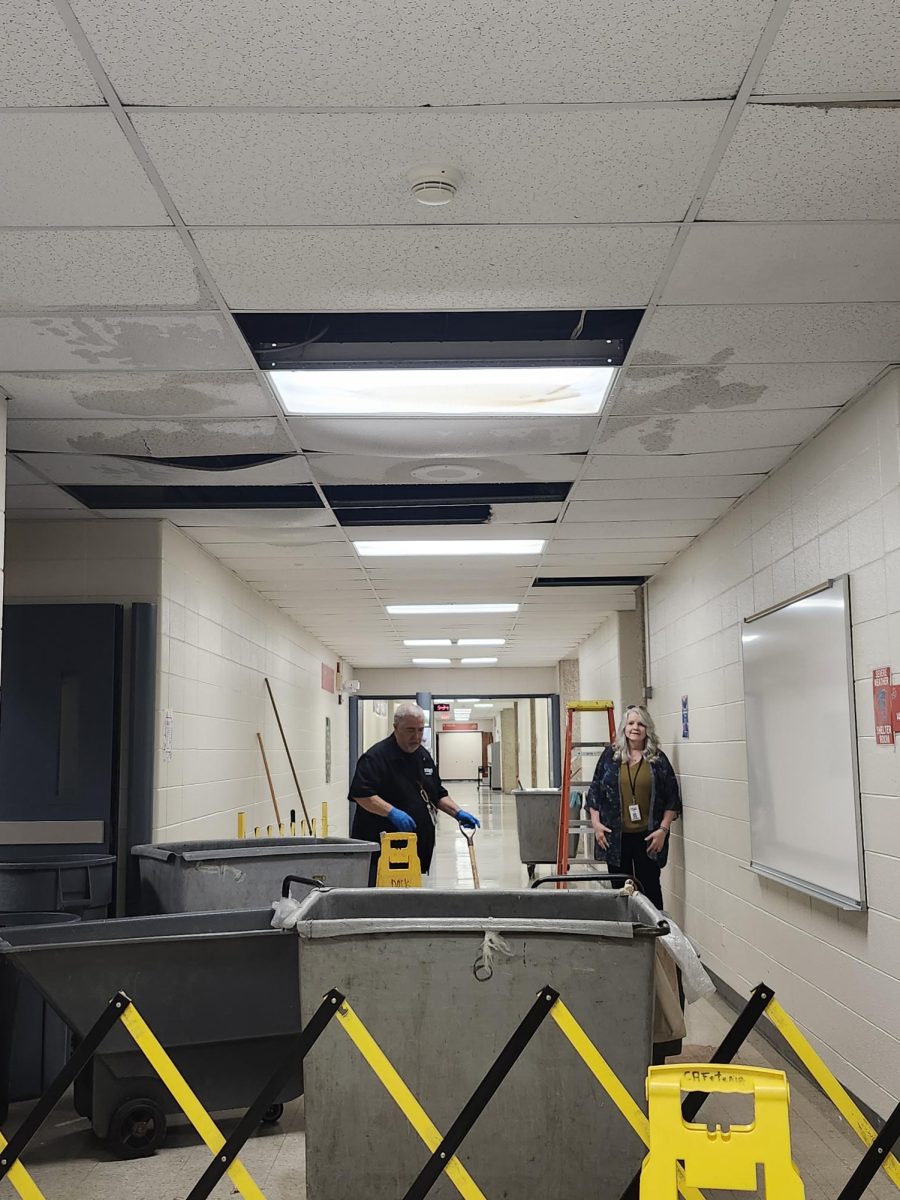 MPS custodians clean up the ceiling tiles and water that poured down after the A/C came back on and condensed water had collected.