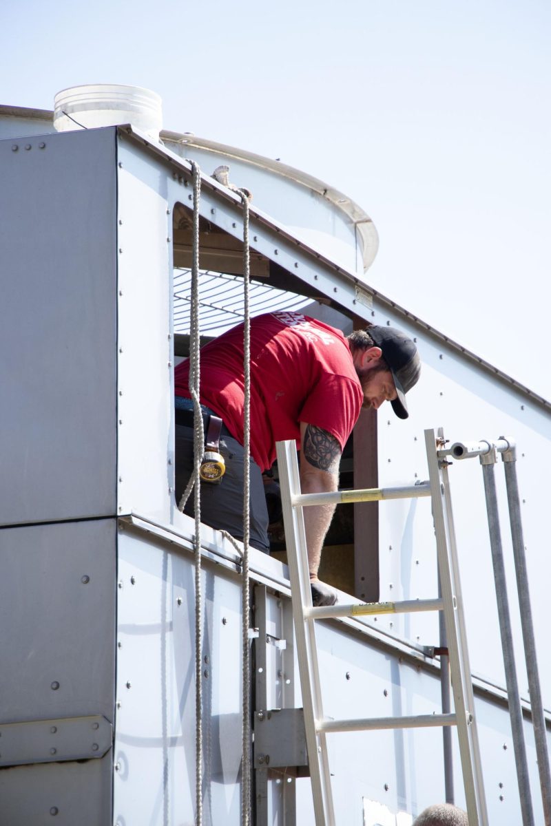 Crews finish installing the new gearbox that should fix the air conditioning in the building.