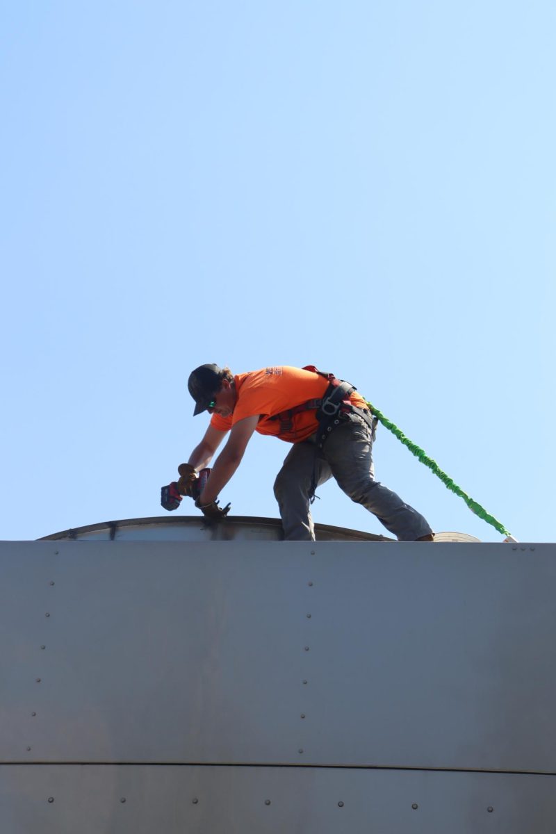 A crew member puts the grate back on the top of the chiller after the new gearbox was lowered in.