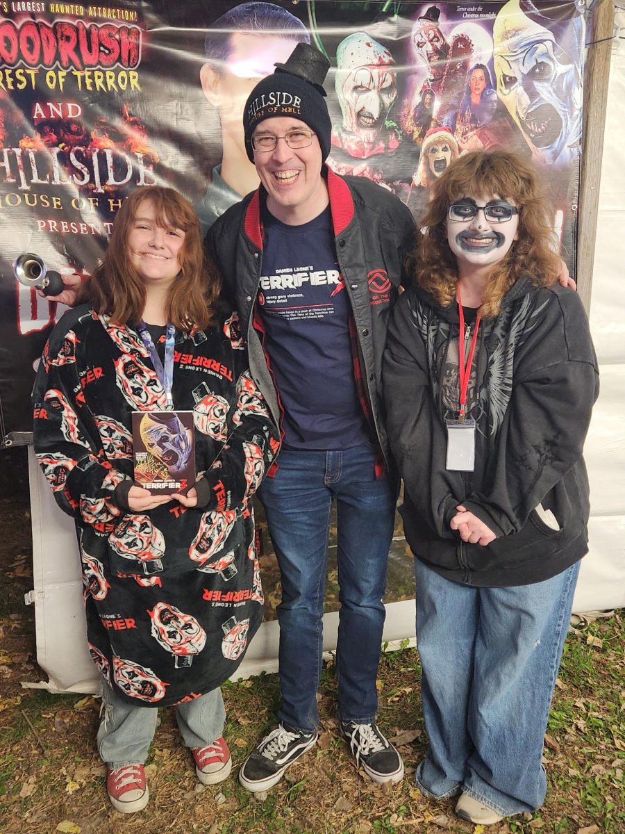 Seniors Tristan Mattingly and August Yancey pose with David Howard Thornton who plays the character Art the Clown. Thornton was visiting the Hillside House of Horror.