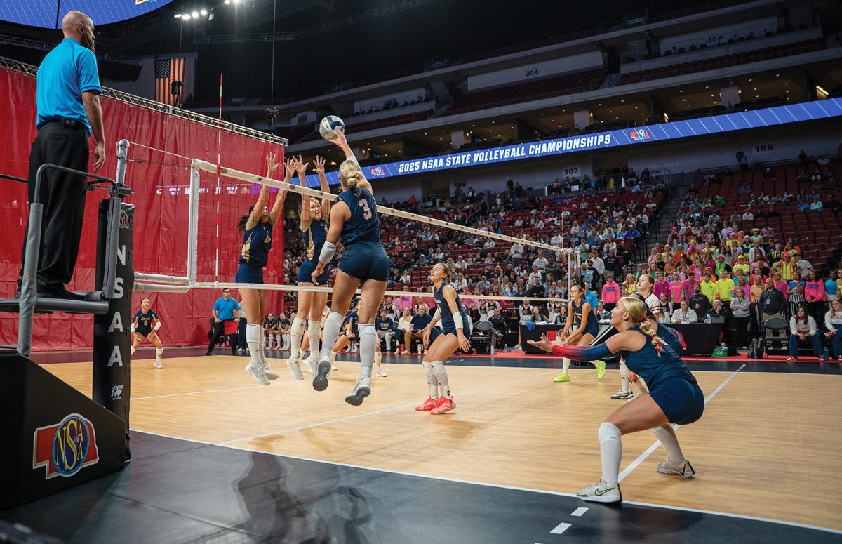 Senior Jamie Murcek tips the ball over the net and scores a point for her team. The Patriots defeated Elkhorn South in 3 sets to advance to the semifinals.
