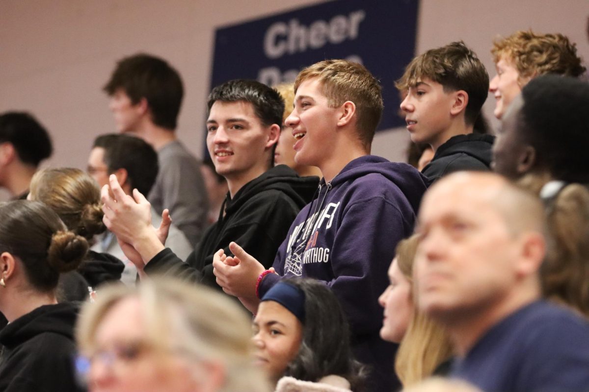 Senior Evan Bradburn and Junior Elijah Gilkerson watch in applause as peprally gets intense with performances from the Pat's baton squad.