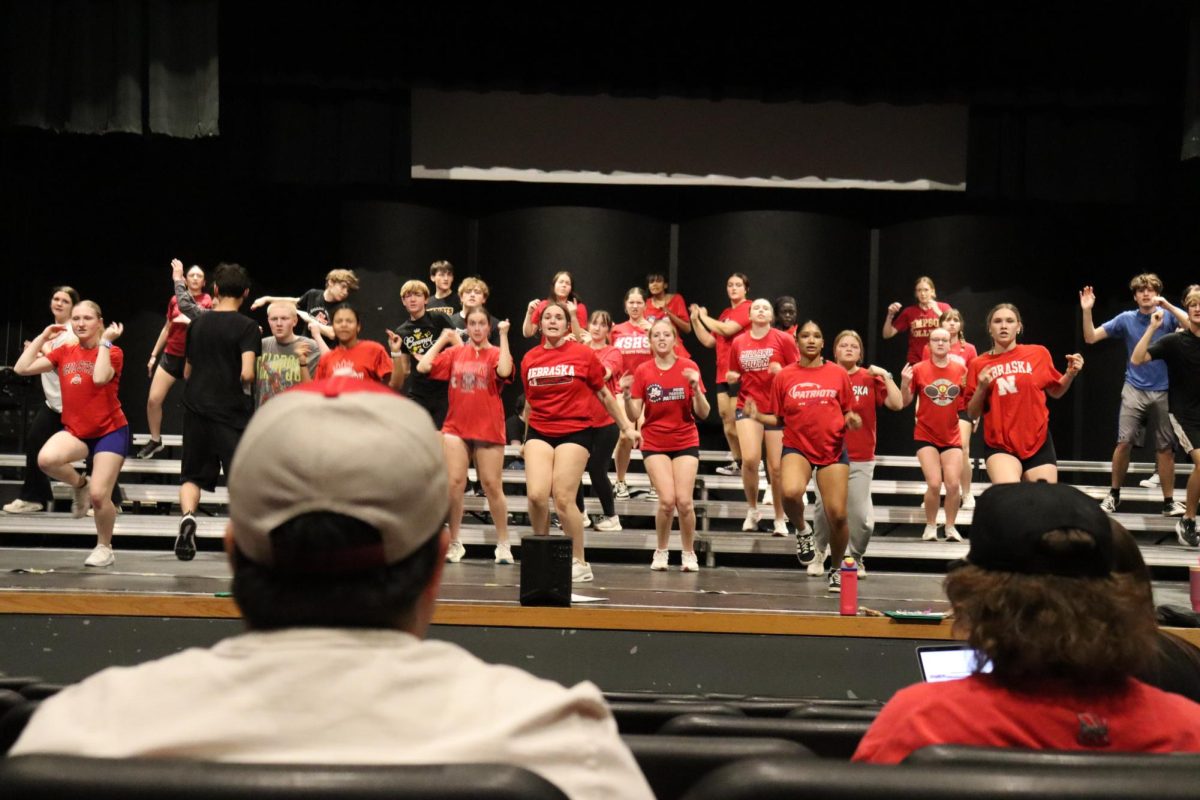 Directors  Edgar Estrada and Braden Bode watch the show choir run their show. 