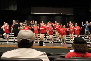 Directors  Edgar Estrada and Braden Bode watch the show choir run their show. 