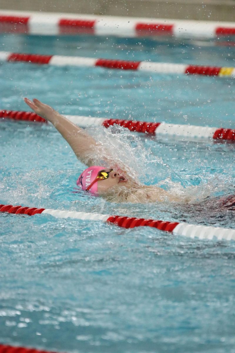 Sophomore Abraham Ayala swims 100 backstroke.