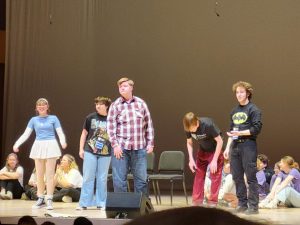 Impov team members, Halle Hinton, Maria Hubert, Rosey Wilken, Toby Schwietzer, and Ryan McConachie perform a scene at the final Showcase. The top four groups got to perform on stage. 