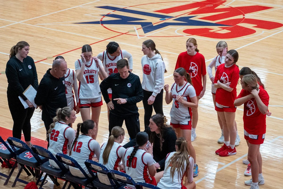 The team strategizes together during a timeout.