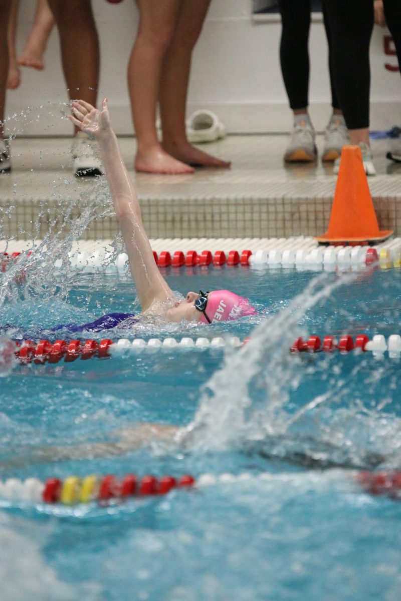 Freshman Jael Andelt swims the 100 backstroke.