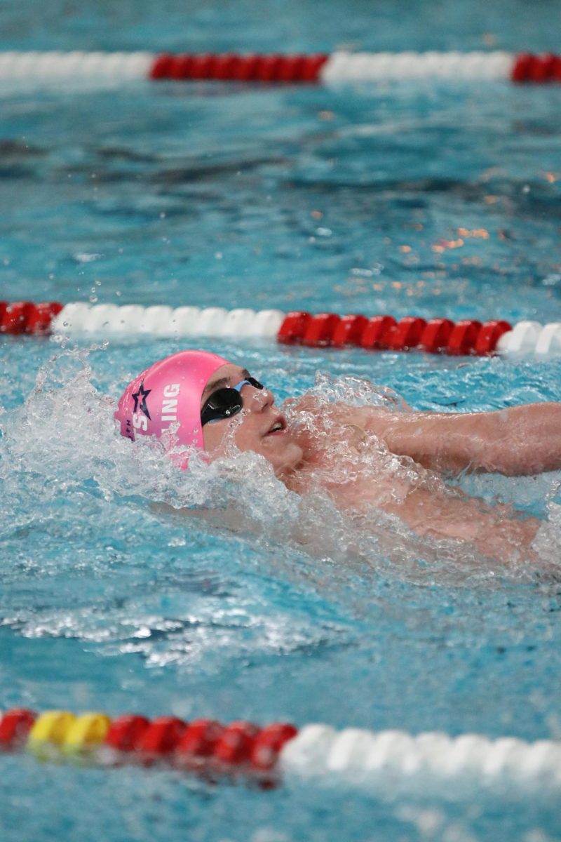 Freshman Elijah Boeschling competes in the 100 back stroke. 