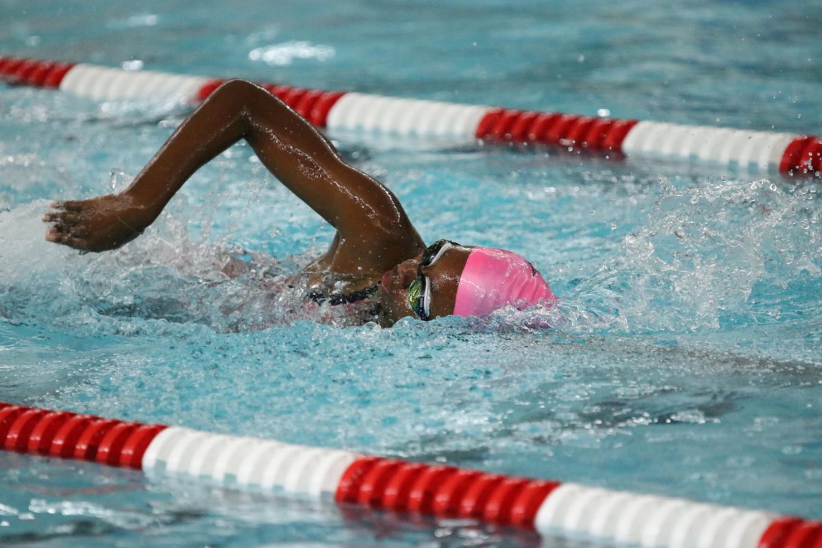 Junior Olivia Caroll swims 100 freestyle.