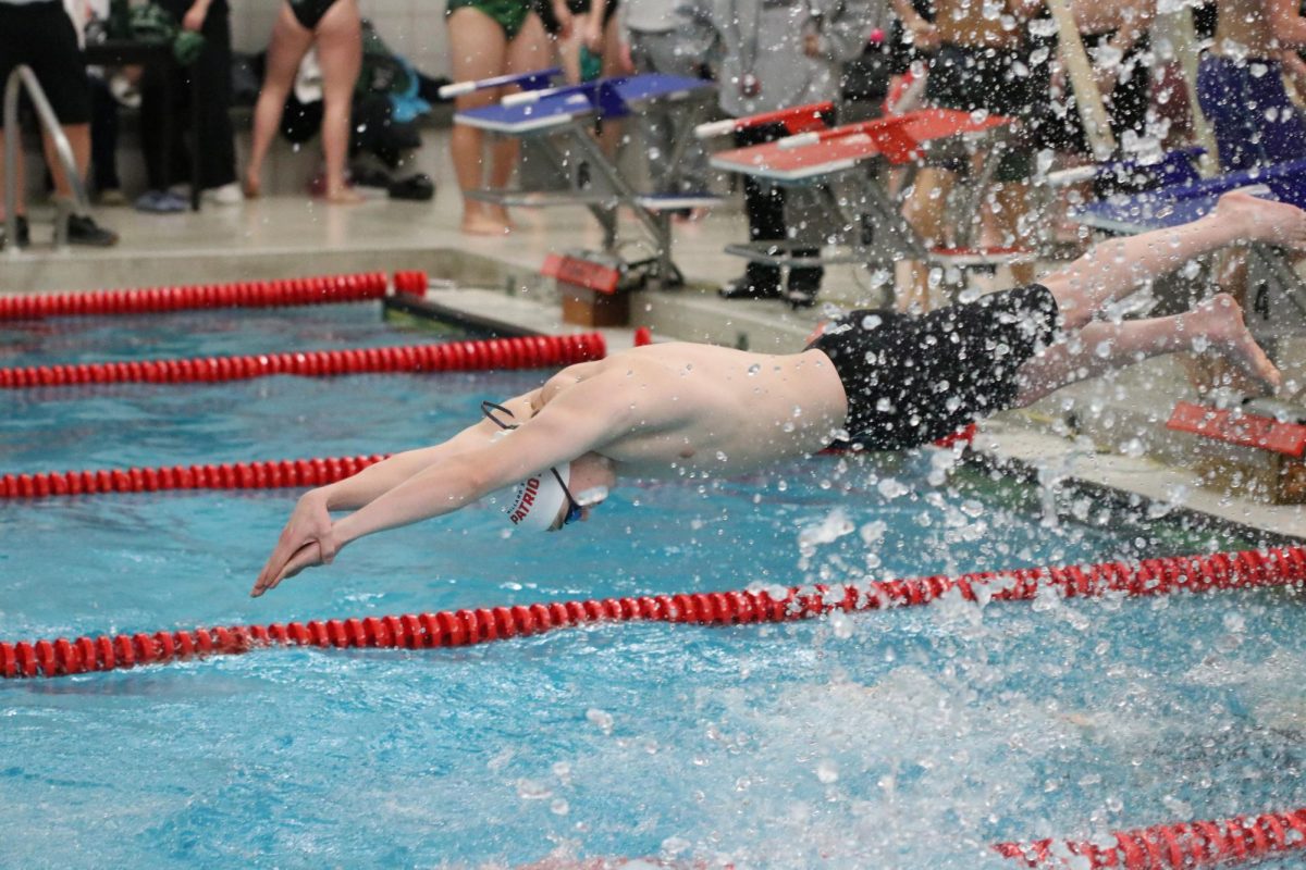 Sophomore Creighton Tesch dives off block.
