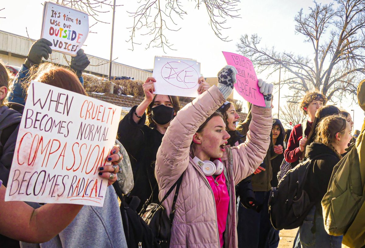 More than 100 students, including freshman PJ Pinkerton, protest ICE in front of the school building facing Q St. as part of a walk out on Jan. 29. Photo by Adalyn Jensen