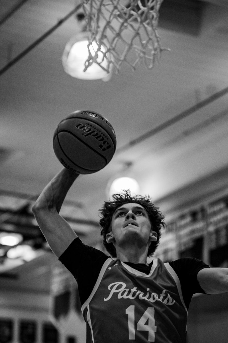 Senior guard Journey Gerlach goes up for a dunk before the district game.