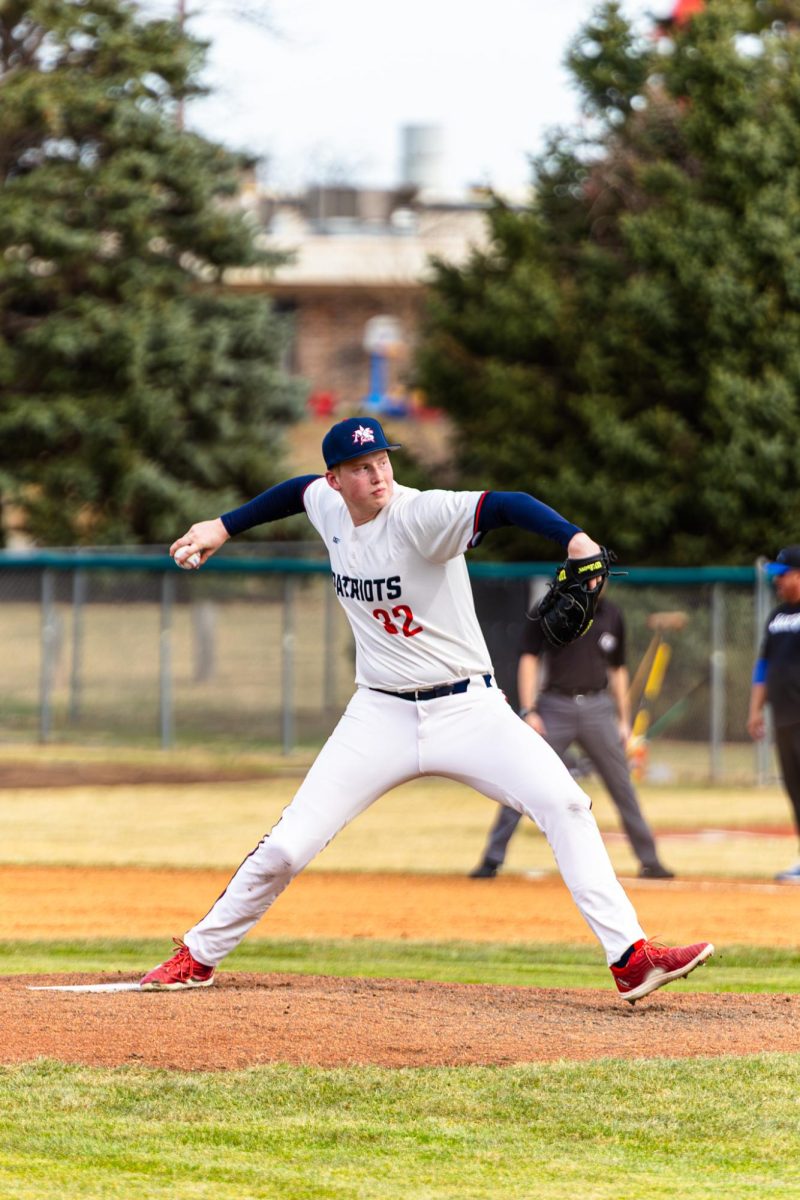 Sophomore Charlie Harding pitches on opening day versus Millard North.