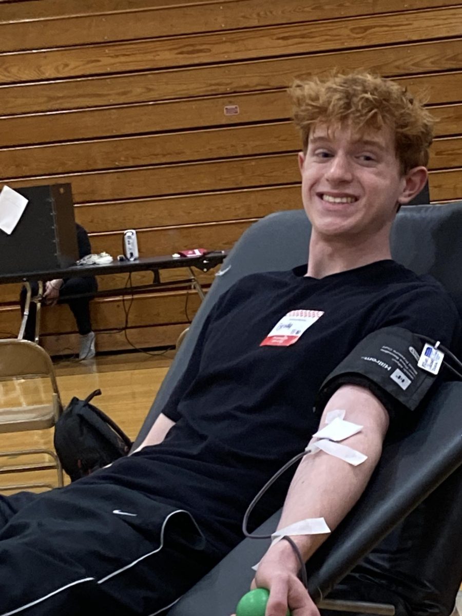 Junior Brody LInnell gives blood.